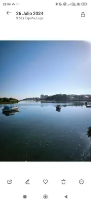 two pictures of a lake with boats in the water at Piso cerca de la playa, dos habitaciones, piscina y terraza in San Ciprián