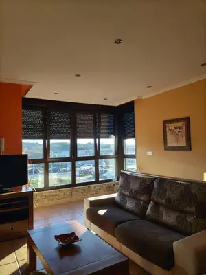 a living room with a couch and a table at Vivienda turistica Os Galegos en Palas de Rey in Palas de Rei