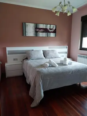 a bedroom with a bed with two towels on it at Vivienda turistica Os Galegos en Palas de Rey in Palas de Rei