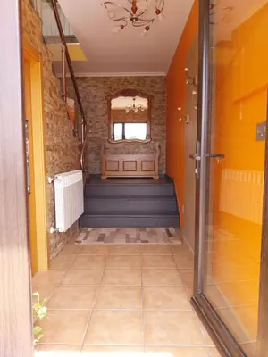 a hallway of a house with blue stairs and a window at Vivienda turistica Os Galegos en Palas de Rey in Palas de Rei