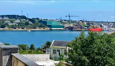 a house with a view of a body of water at Apartamentos Buenos Aires,en el centro de Ribadeo con vistas a la ría in Ribadeo