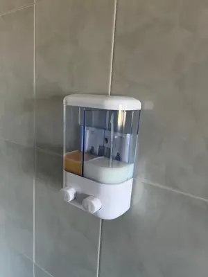 a soap dispenser on the wall of a bathroom at Ático Calvo Sotelo 217 in Sarria