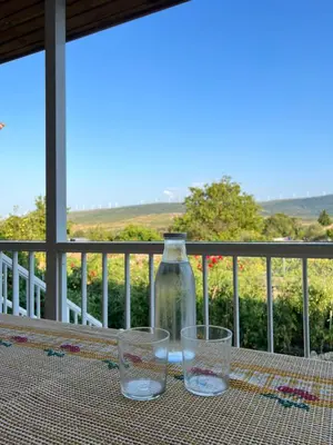 a table with chairs and a table with apples on it at Apartamento Amanecer in Baltar