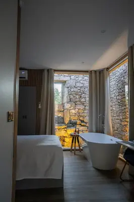 a bedroom with a bed and a bath tub in it at as Alvarizas in Moraña