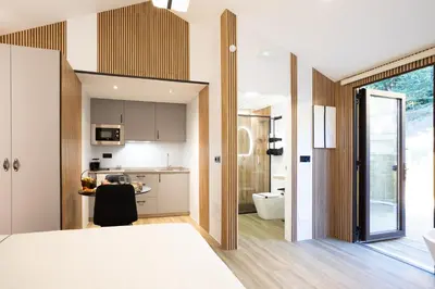 a kitchen and living room with a bed and a bathroom at as Alvarizas in Moraña