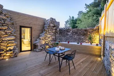 a patio with a table and chairs on a wooden deck at as Alvarizas in Moraña