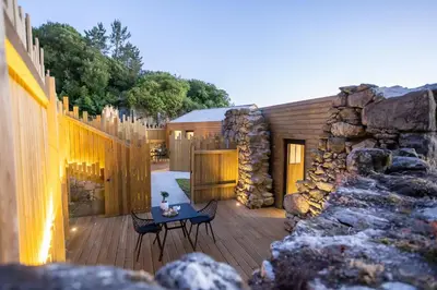 a patio with a table and a stone building at as Alvarizas in Moraña