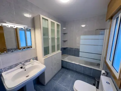 a bathroom with a sink and a toilet and a tub at O Nido de Noe in Melide