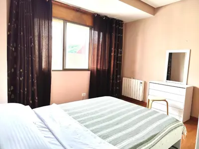 a bedroom with a bed and a window and a television at Piso de Alba in Chantada