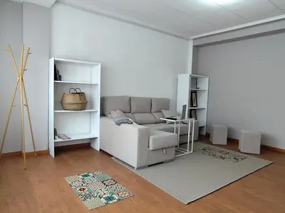 a living room with a couch and a table at Piso de Alba in Chantada