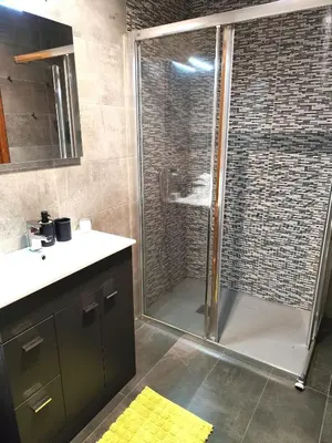 a bathroom with a shower with a glass door at Piso de Alba in Chantada