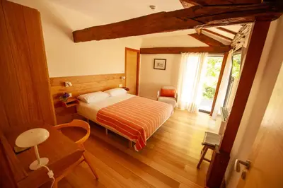 a bedroom with a bed and a wooden floor at Casa do Cereiro in A Estrada