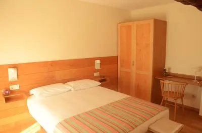 a bedroom with a bed and a chair at Casa do Cereiro in A Estrada