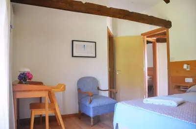 a bedroom with a bed and a desk and a chair at Casa do Cereiro in A Estrada