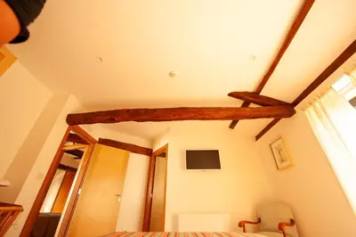 a bedroom with a bed and a wooden beam at Casa do Cereiro in A Estrada