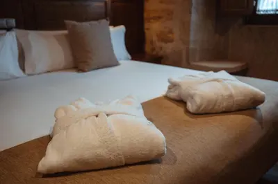 a hotel room with two towels on a bed at Pazo Arretén in Padrón
