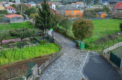 a view of a garden with a fence and a street at Mirador del Camino in Melide