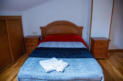 a bedroom with a bed with two towels on it at Mirador del Camino in Melide