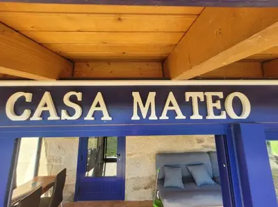 a casa marico sign on a building with a bed at Casa Mateo in Allariz