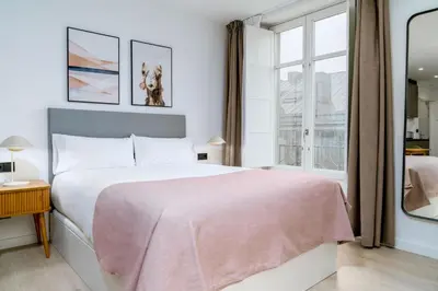 a bedroom with a large bed and a window at Limehome Santiago de Compostela in Santiago de Compostela
