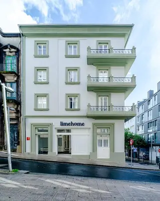 a large white building with a sign on it at Limehome Santiago de Compostela in Santiago de Compostela