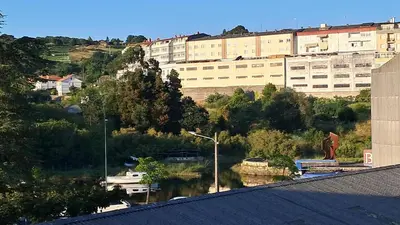 a view of a building and a body of water at Apartamento La Ribera in Betanzos