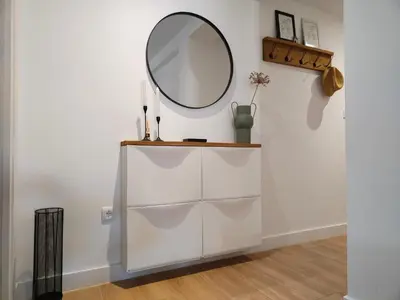 a mirror on top of a white dresser in a room at Apartamento La Ribera in Betanzos