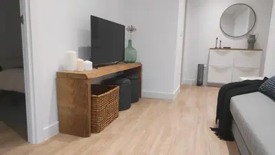 a living room with a television on a wooden table at Apartamento La Ribera in Betanzos