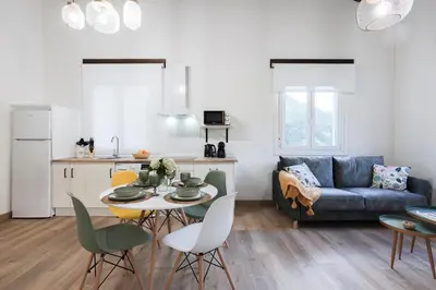a living room with a table and a couch at Apartamentos Bágoas de Mencía Peares Ribeira Sacra in Carballedo