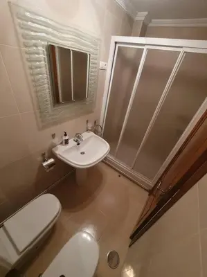 a bathroom with a toilet and a shower and a sink at Casa en zona rural in Cervo