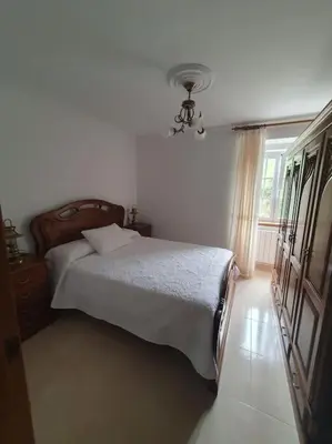 a bedroom with a bed and a window at Casa en zona rural in Cervo