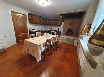 a kitchen with a table and chairs in a room at Casa en zona rural in Cervo