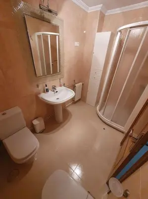 a bathroom with a toilet and a sink and a shower at Casa en zona rural in Cervo