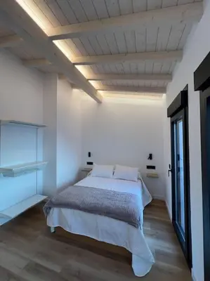 a bedroom with a bed in a white room at Carud Nº15 in Monforte de Lemos