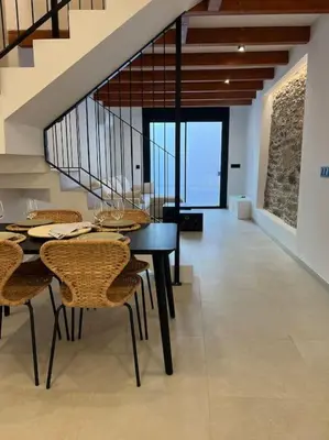 a dining room with a black table and chairs at Carud Nº15 in Monforte de Lemos
