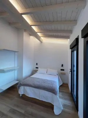 a bedroom with a bed in a white room at Carud Nº15 in Monforte de Lemos
