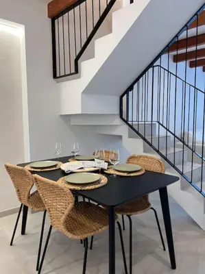 a dining room with a black table and chairs at Carud Nº15 in Monforte de Lemos