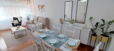 a living room with a table and a couch at Home Ourense Miño in Ourense