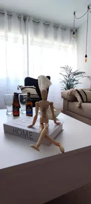 a wooden mannequin on a table in a living room at Home Ourense Miño in Ourense