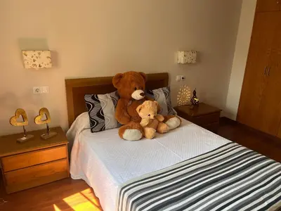 two teddy bears sitting on top of a bed at A Xanuca in Taramundi