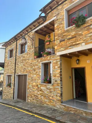 a brick building with flower boxes on the windows at A Xanuca in Taramundi