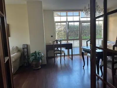 a living room with a table and chairs and a dining room at Mar y Playa con Jardín in A Coruña