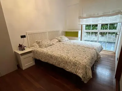 a bedroom with a bed and a window at Mar y Playa con Jardín in A Coruña