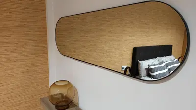 a mirror on a wall with a pile of towels at Orballo in Ourense