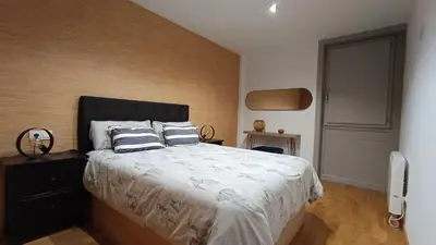 a bedroom with a bed with two pillows on it at Orballo in Ourense
