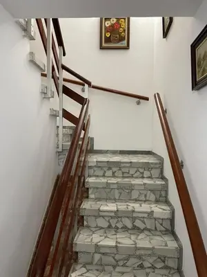 a staircase with stone steps and a painting on the wall at Acogedora casa a pie de playa in Cillero