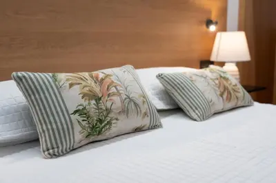 two pillows sitting on top of a bed at Duerming Avenida 85 Burela VUT in Burela de Cabo
