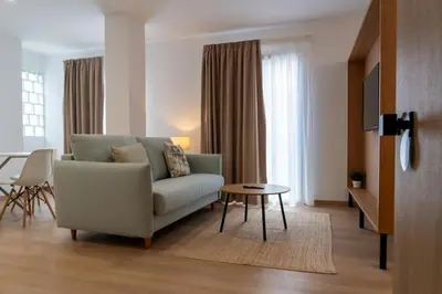 a living room with a couch and a table at Duerming Avenida 85 Burela VUT in Burela de Cabo