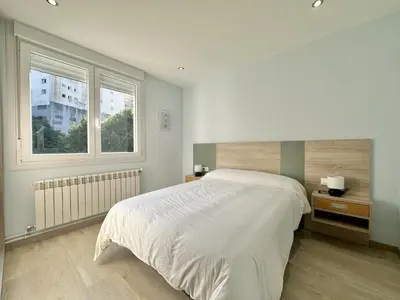 a bedroom with a white bed and a window at Front Beach I in Sada