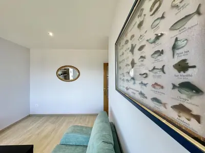 a living room with a wall mural of fish at Front Beach I in Sada